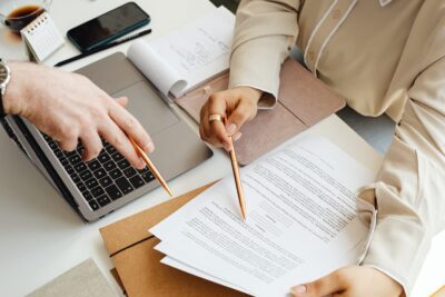 Employee and attorney reviewing documents to file an unpaid overtime claim