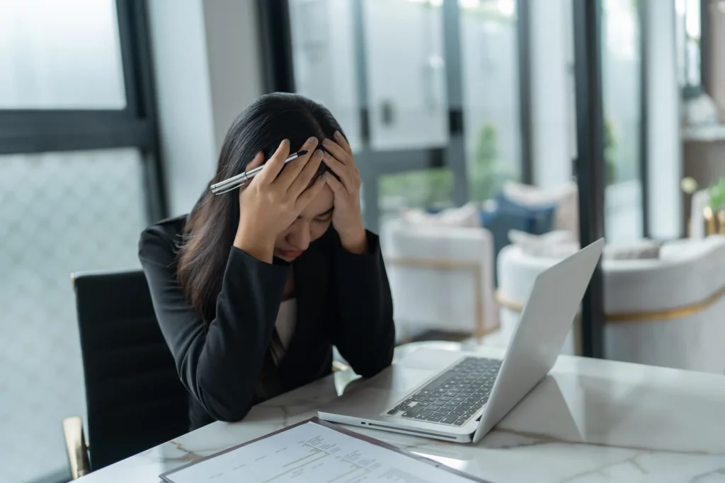 Woman stressed at work, Atlanta unpaid wage attorney