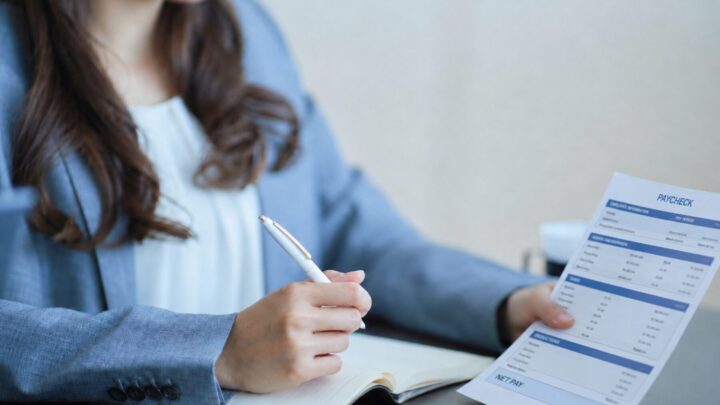 Salaried employee reviewing a paycheck to determine whether overtime pay was included under FLSA rules.